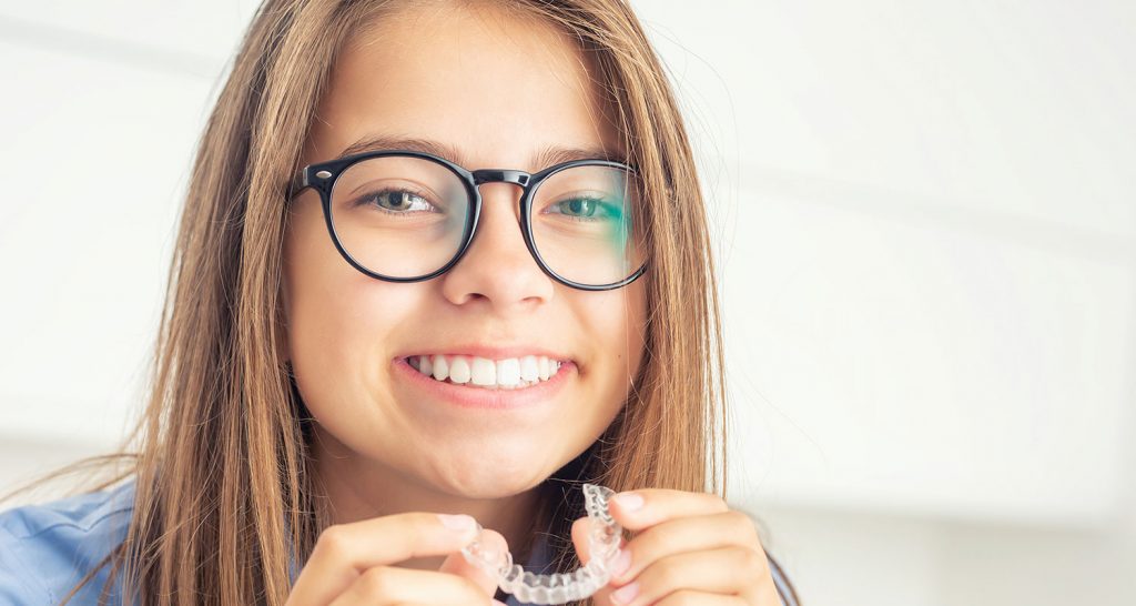 Young girl with an Invisalign clear aligner.