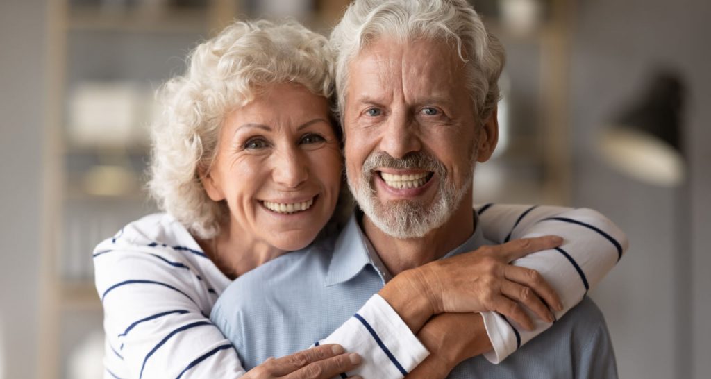 Older couple smiling together.