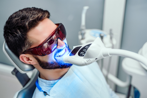 man getting teeth whitening treatment