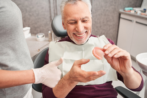 older man receiving dentures